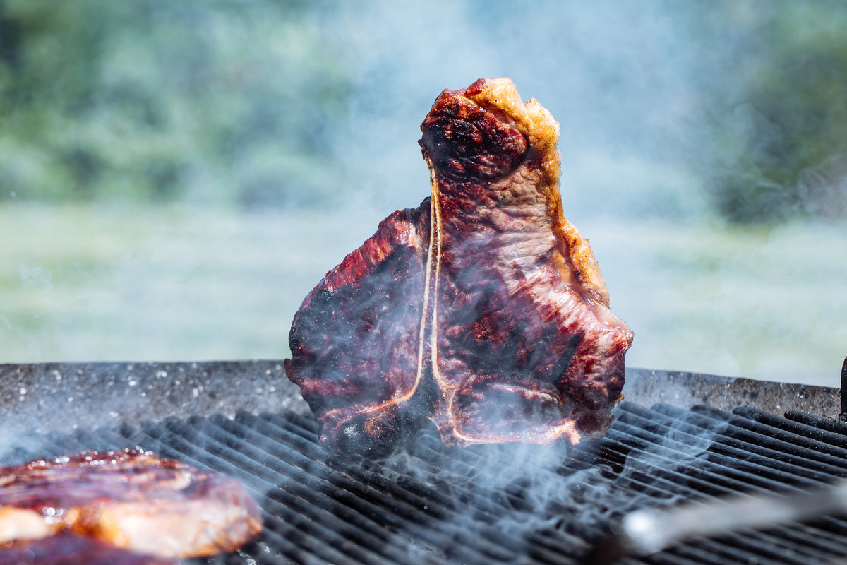 Steak cooking over an open grill